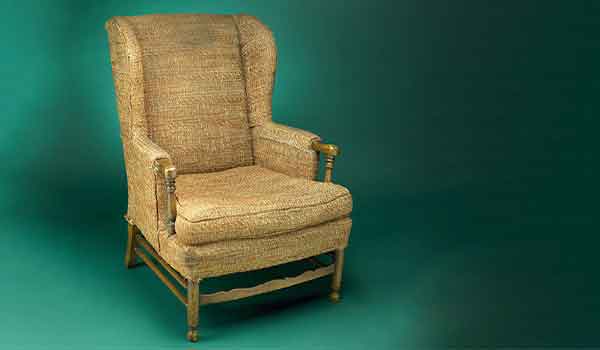 From His Tattered Chair, TV's Archie Bunker Caricatured