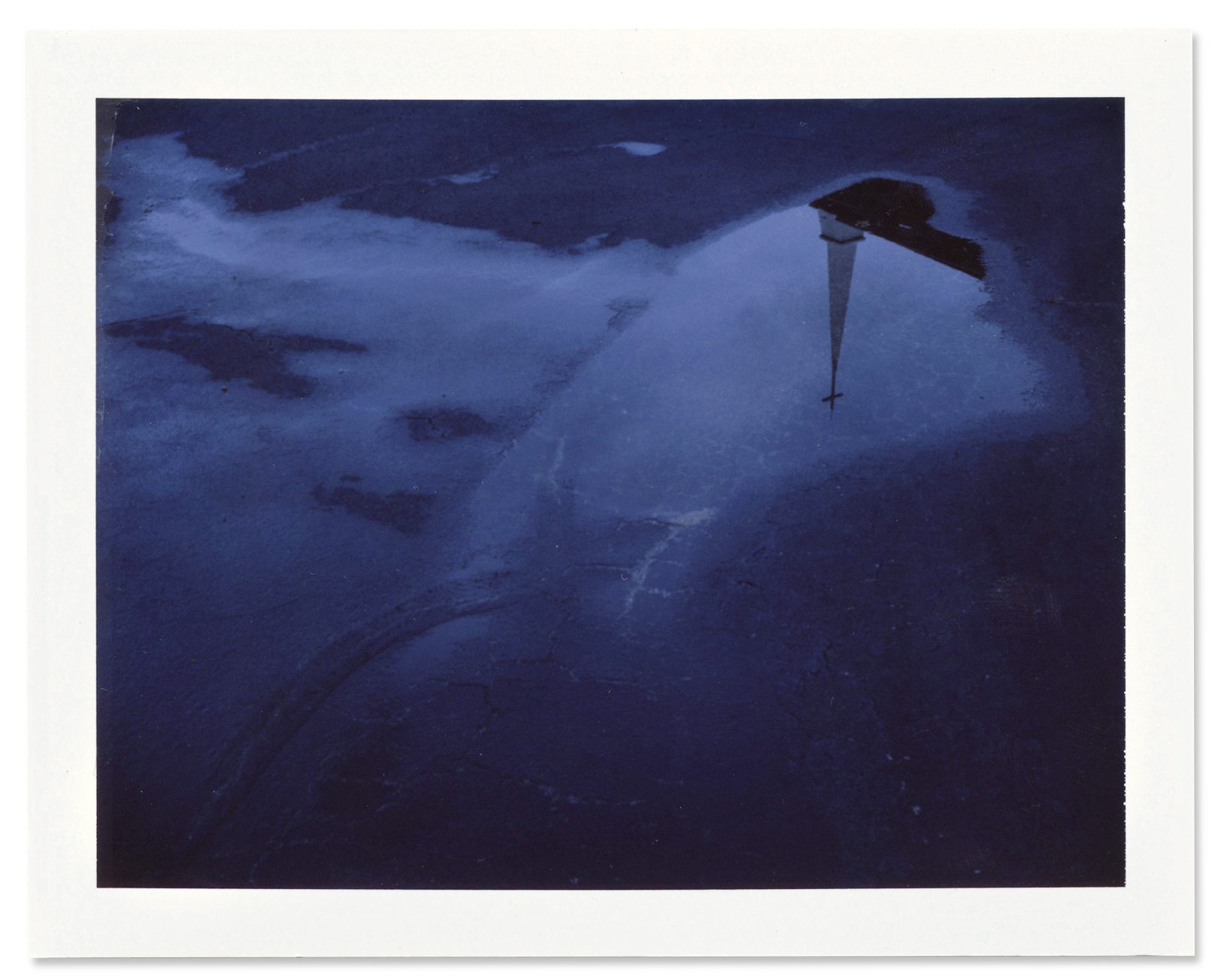 The steeple of the Oak Mountain Baptist Church is reflected in a rain puddle.